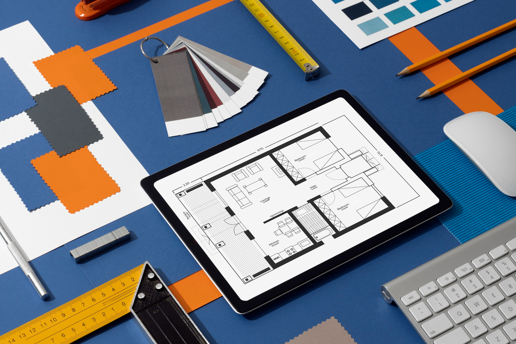 A digital device, likely a tablet, displays a floor plan layout of a home or apartment. This could be used for planning spaces in custom home building or interior design.